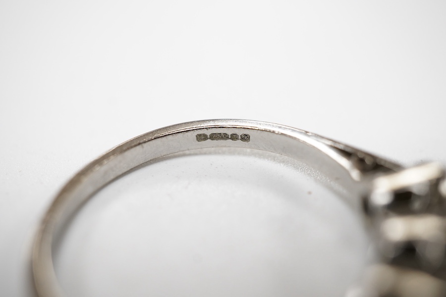 A three-stone diamond ring, set with three brilliant-cut diamonds totalling approximately 0.50 carats, mounted in platinum, size R1/2, British hallmarks, gross weight approximately 4 grams